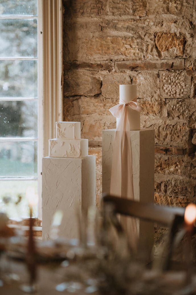 Wedding cakes displayed on plinths styled with silk ribbon Wedding cakes displayed on plinths styled with silk ribbon